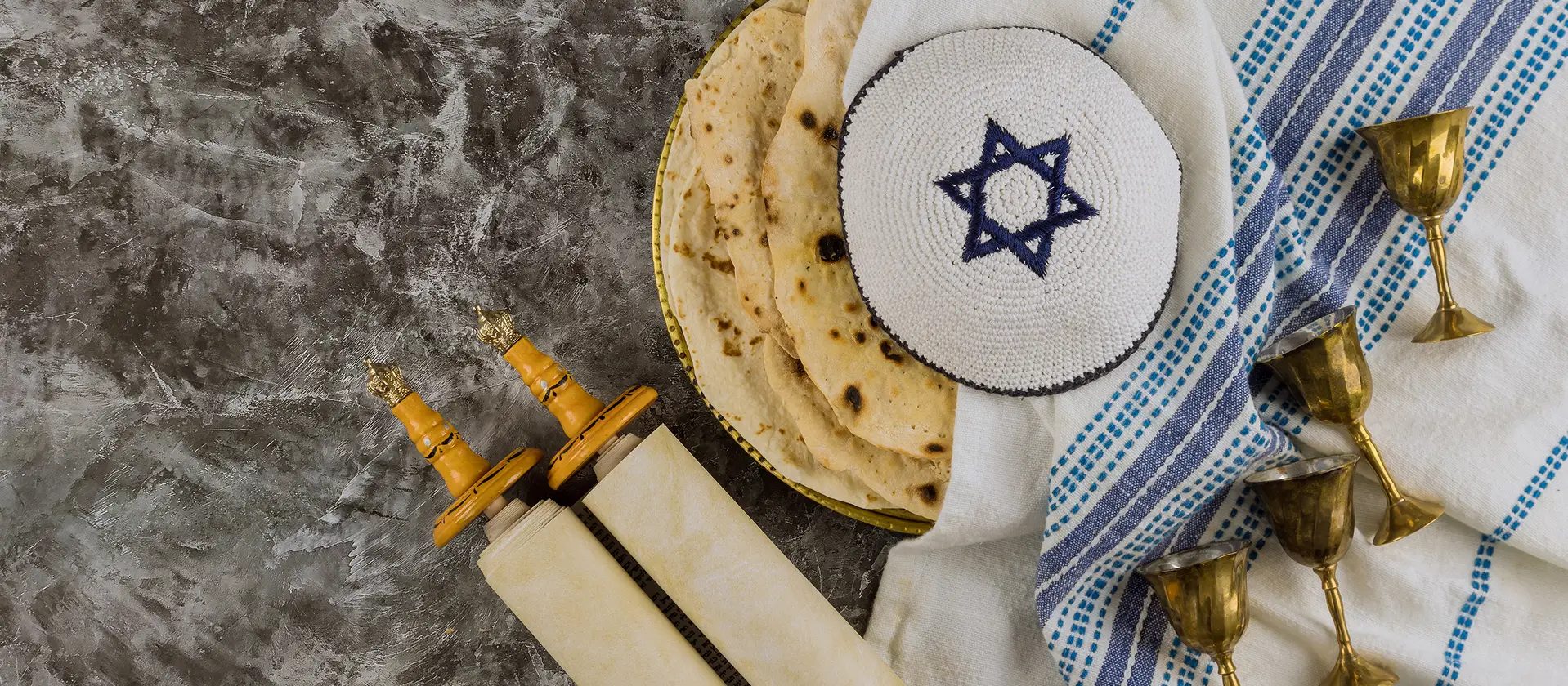 Torah scroll, kiddush cup and tallit representing the Jewish communities DigitalShul serves