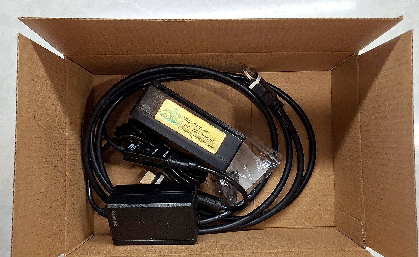 The complete DigitalShul kit packed in its shipping box: micro computer, power supply and HDMI cable